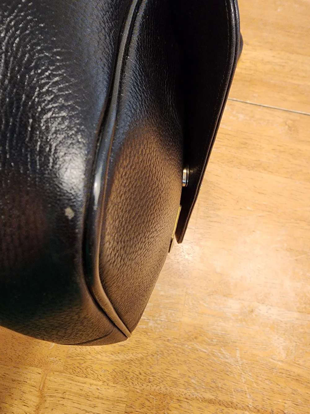 vintage MCM black pebbled leather studded crossbody bag featuring a front plaque
